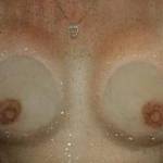 During the business trip, my coworker (he's so naughty) dared me to press my titties against the shower door