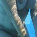 An underwater view of my tits with their pierced nipples.