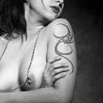 A friend wanted me to photograph her chained nipple rings and show her tattoo