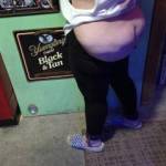wife trying out the new restraints on the wall in the bar