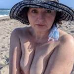 My new cybersex slut wife friend, Barb! Exposing her tits for us "Peeping Toms" on the beach here. I hope she is turning you on to view more!