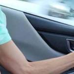 One hand on the steering wheel, the other hand on the stick shift.