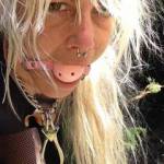 tied outside, with dog collar and gagball