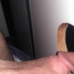 Sticking my hard cock through a glory hole at the porno shop.