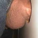Getting my dick sucked through a glory hole at the porno shop