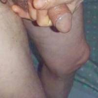 A frontal close up from above as I use my hand to smear/rub essential oil/massage lotion upon my dick as I stand in early May 2025 & another TG810 camera was used.