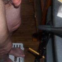 A lower body view of my dick, legs and feet as I stand on a step near my recliner... I adjusting a S70 camera near my recliner. Late April 2025. Z50 camera is used.