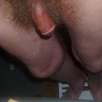 A frontal lower body view as I stand a small portable step near my recliner... my dick is still a red wood color after rubbing the tong balm upon it... late April 2025. Z50 camera was used.