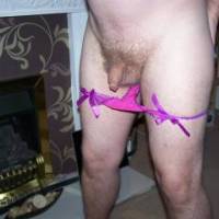 purple panties pulled down to show small dick