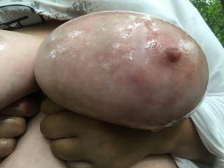 A close-up of baby oil on lovely left tit