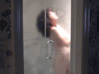 wife takes a steamy shower in hotel room