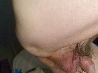 A side smaller/flaccid view of my dick and balls with lube between my balls and dick- specifically in my hair...in late April 2025. FZ 150 camera was used.