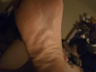 My wifes foot while she plays with herself
