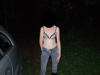 Showing off her bra for some friends in a car park