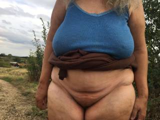 Last picture of the afternoon, sadly. Walking back downhill she pauses on a bend and shows just her cunt, no tits - apart from hard nipples under her shirt ;)
