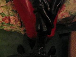 Anna milking a rubber covered cock in her shiny latex gloves.