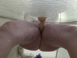 Kit playing in the shower, with a suction cup dildo and her vibe...