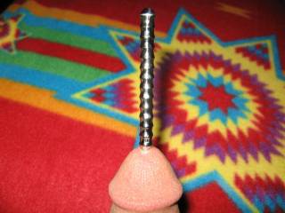 Urethra stimulator half inserted. This is a 91/2 " steel rod with ribbing on most of its length. It feels good as it rubs where I\'ve never been rubbed before. Ive got my own divining rod-wonder if I could find water in the ground with it??? A $ maker? hmm