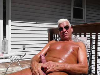 Naked outside getting a suntan play with cock.