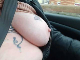 In the car... seat belt on... top up.. tits on show!   Sally on a normal day!