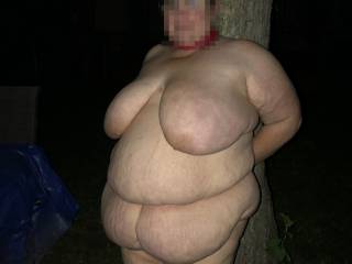 Leaning up next to a tree with a body saying check me out.