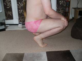 crouching down in pink panties