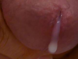 Extreme focus on the head oozing cum