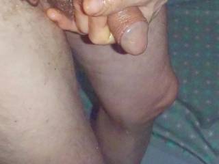 A frontal close up from above as I use my hand to smear/rub essential oil/massage lotion upon my dick as I stand in early May 2025 & another TG810 camera was used.