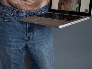 Some of my favorite photos are of beautiful women wearing jeans (see ilovedoggystyle1's profile for some very hot examples). In the forums, SensualSage recently expressed a similar interest in seeing pictures of men in jeans. (That's her on the computer.)