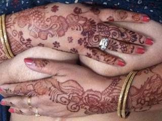 Indian wife's big tits covered by her beautiful, decorated hands.