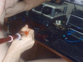 A partial body side selfie as I grasp my land phone as I sit at my desk/PC... in early May, 2025... TG810 camera was used.
