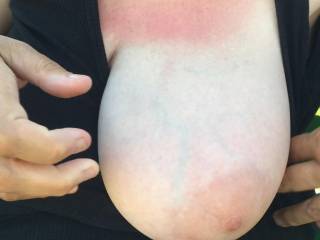 3 of 3 - over the neckline of her shirt, out comes one tit. Ready to be suckled