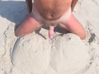 Hubby laying his dick on the tit sand sculpture.