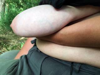 Needing a rest, from all the excitement, I sit next to my lovely friend on the log for a while. Shortly afterwards, her tanned left arm held up her pale and long left tit - requesting it be played with, when I am ready ...