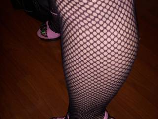 A shot of Jen\'s sexy legs in fishnets and stripper heels.