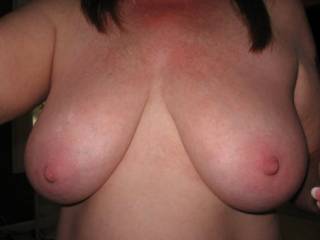 Another view of those fabulous 36DD's. They need a dick or load of cum for decoration, any takers?