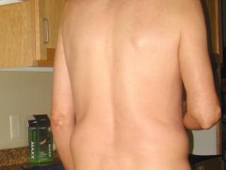 A partial body view that includes my butt as I stand near my dishwasher/microwave area in the kitchen... you can see a box that the new toy was packaged in on the counter... Early May 2025. A S70 camera was used.