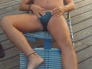 tanning in the HOT SUN  with just a thong on