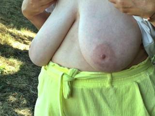 At the base of a steep hill a lady shows her big tits to a friend
