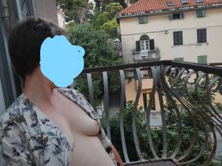 On holiday in Croatia this summer, getting ever more comfortable to strip out of her clothes in full view of the people on the street below.