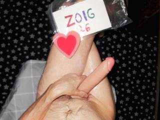 A partial body sitting view from just below my chest on down to my knees with my left leg crossed over my right leg as I toy play. A W290 camera was used.