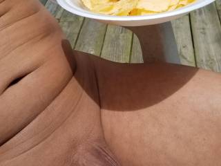 Having lunch after mowing the grass nude.