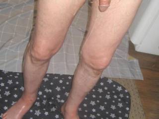 A lower body frontal and my legs have lube running down them as I stand in my kitchen after some toy play in early May 2025. Canon 630 camera was used.
