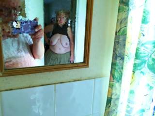 The photographer lets her in and says he will be in the bathroom when she is ready. A few minutes later he is checking the camera - behind him she has changed into the clothes he got her, and with tits out leans against the door frame - I am ready ...