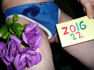 Cum upon my underwear as I sit with balls showing partially & a flower nearby.