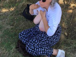 From the previous picture she now has both tits out. The photographer asks her to hold the pose there - keeping her shirt up, proudly showing that tit, and wearing sunglasses