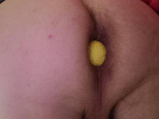 Yellow golf ball peeking out of my ass