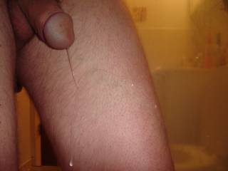 A long strand of pre-cum dripping down my leg