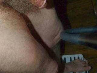 A partial body frontal side view of my dick and hair as I stand on a small step stool in late April 2025. FZ150 camera was used.