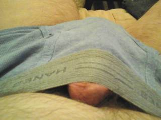 His dick getting hard starting to poke out of his briefs waistband.